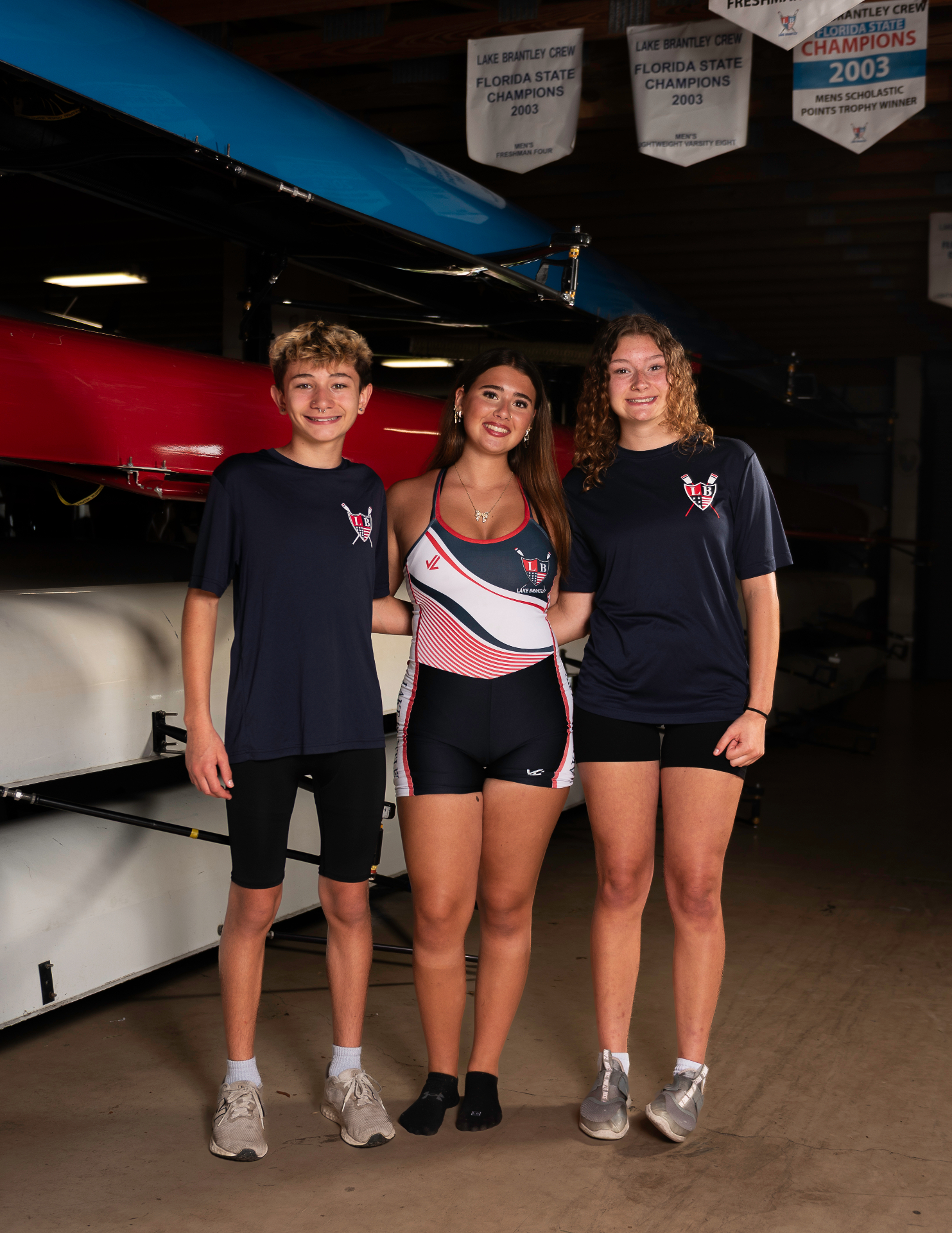 LBRA middle school rowers in the boathouse beneath championship banners