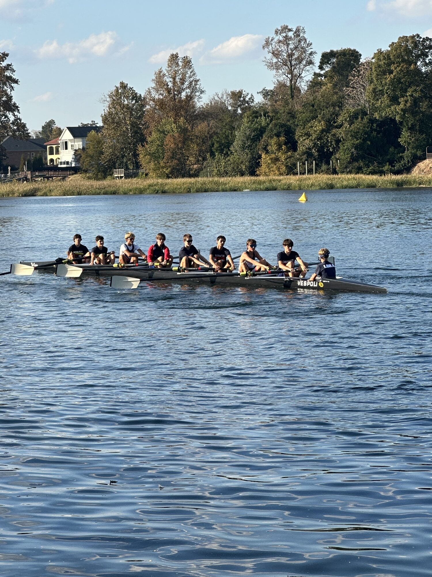 LBRA boys 8+ rowing across a wide stretch of the Augusta race course with houses on the far bank
