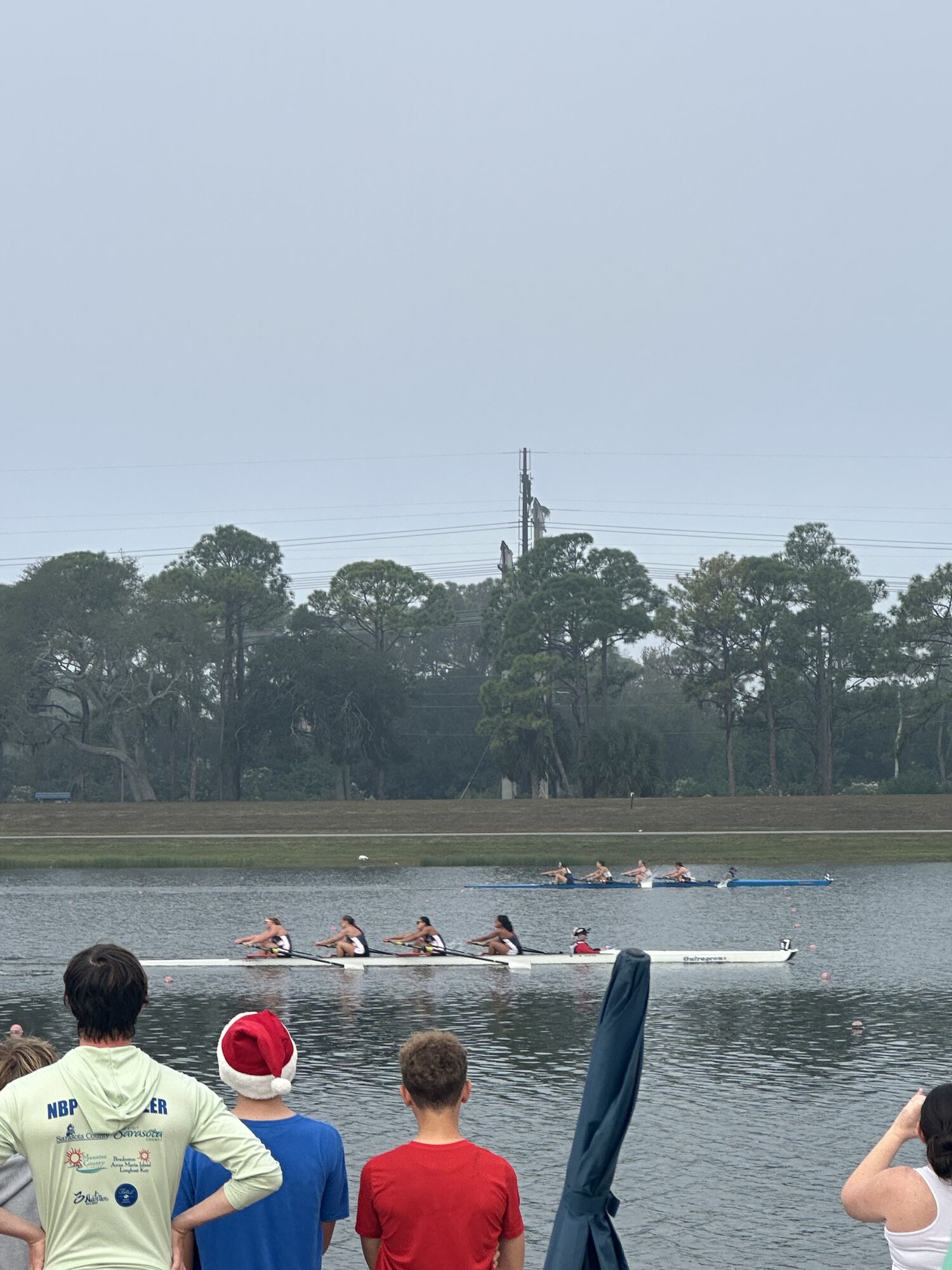 Foggy dawn at Sarasota with an LBRA rower in a Santa hat at the December regatta